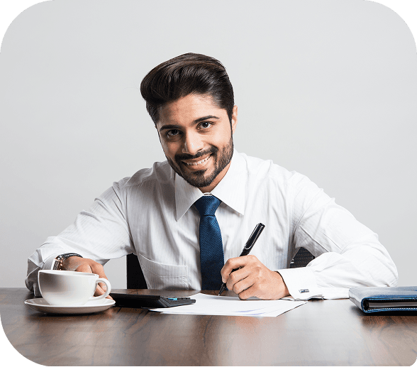 Educator working at a desk with notes and coffee